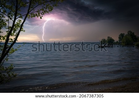 lightning from a thunderstorm strikes a lake
