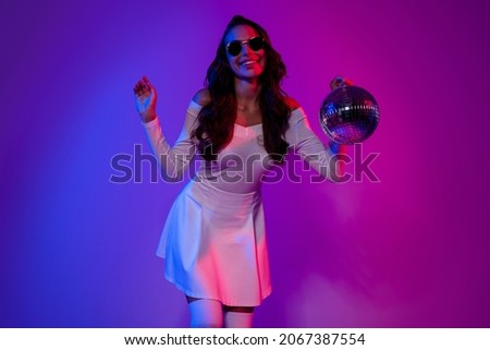 Photo of cool young lady hold ball dance wearing white dress eyewear socks isolated over gradient color background