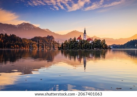 Lake Bled, Slovenia. Sunrise at Lake Bled with famous Bled Island and historic Bled Castle in the background. Royalty-Free Stock Photo #2067401063