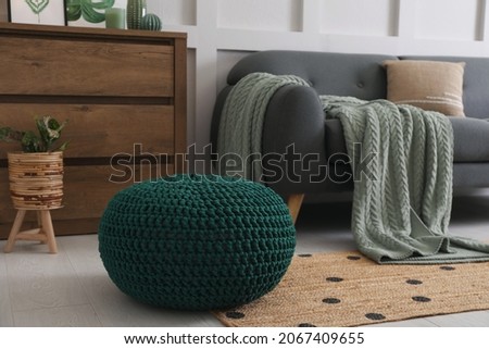 Knitted pouf near sofa in living room Royalty-Free Stock Photo #2067409655
