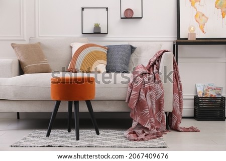 Stylish living room interior with ottoman, sofa and decor Royalty-Free Stock Photo #2067409676