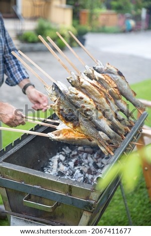 Fish grilled on a stick