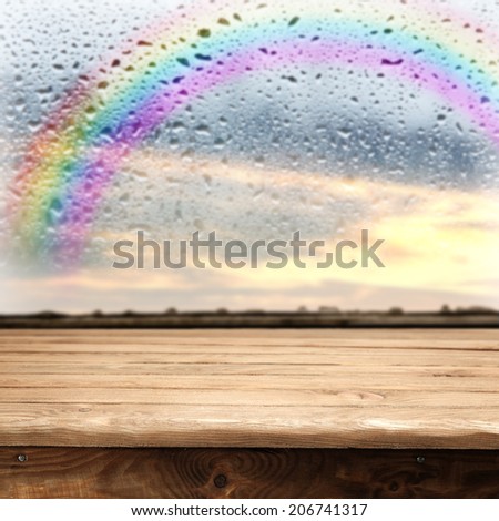 window sill table of wood and rainbow on the sky 