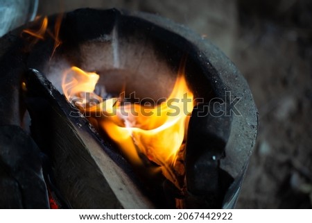blurred picture of fire and white smoke in soil stove countryside kitchen, dark tone
