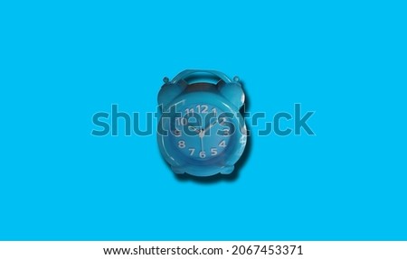 Single analog alarm clock isolated on light cyan for background or stock photo, clock telling time, object, product 