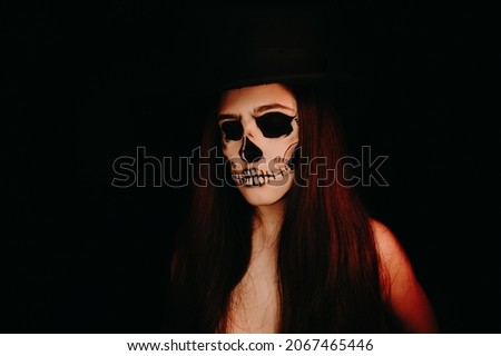 A girl with skull make up. Halloween happy party.