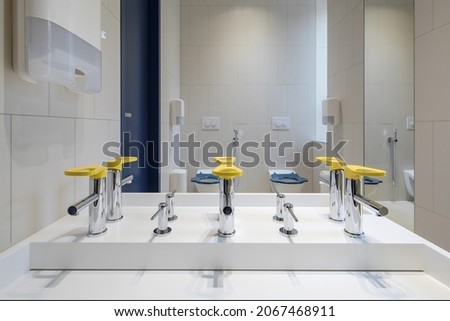 Modern public restroom for children minimal interior yellow and blue details. Children healthcare concept