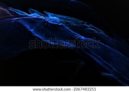 Abstract blue electric wave on black technology background. Neon light paint in water, acrylic explosion, fluid liquid art