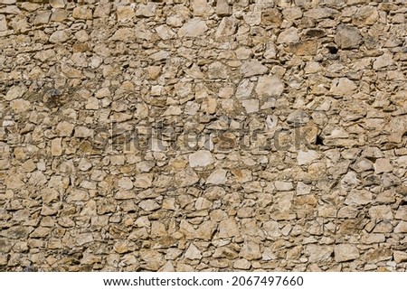 Stone castle wall background from limestone segments. Texture for further graphic processing