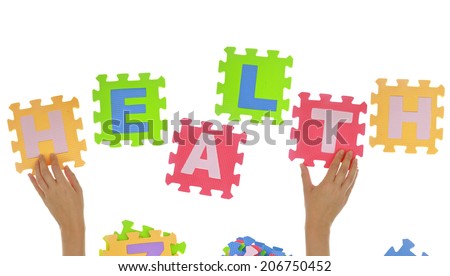 Hands forming word "Health" with jigsaw puzzle pieces isolated 