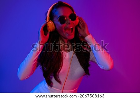 Photo of hooray young dj brunette lady listen music look advert wearing white top eyewear isolated over gradient colorful background