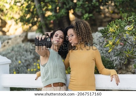 The two Spanish caucasian females doing selfies