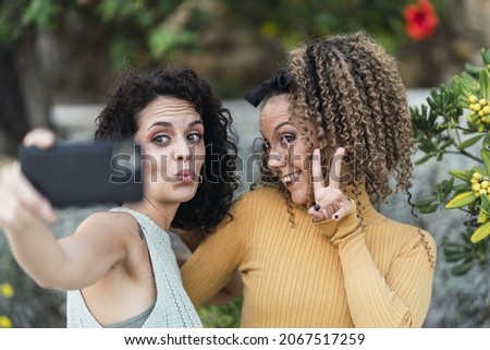 The two Spanish caucasian females doing selfies