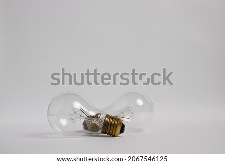 Two light bulbs against white paper background.
