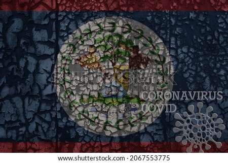 flag of belize on a old vintage metal rusty cracked wall with text coronavirus, covid, and virus picture.