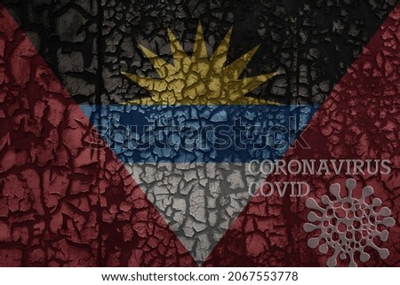 flag of antigua and barbuda on a old vintage metal rusty cracked wall with text coronavirus, covid, and virus picture.