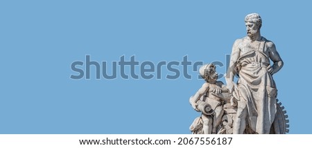 Banner with sculpture of old engineer and his scholar on Custom Bridge in Magdeburg downtown, Germany, at blue sky solid background with copy space. Concept of historical architecture heritage