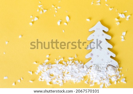 Christmas background with fir-tree on yellow background