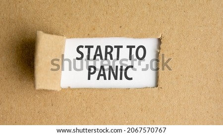 the text start to panic appearing behind torn paper, concept