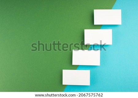 Business card blank over colorful abstract background. Corporate stationery branding mock-up. Copy space for text. Top view