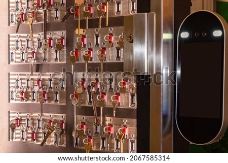 Intelligent key storage systems. Key storage and distribution system. Metal clef cabinet with a transparent window. Equipment for issuing key on a magnetic card. Security and access control systems Royalty-Free Stock Photo #2067585314