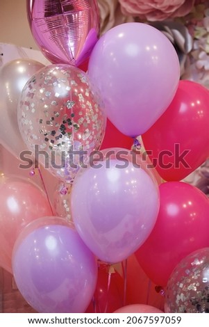 The balloons are glossy pink and white colors as decoration on children's holiday or birthday party.