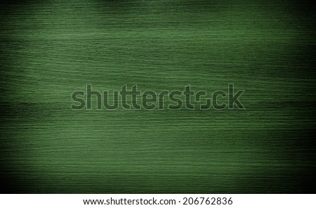 Dark green wood. Natural texture background. Vignette and shadow effect.