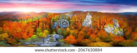 Aerial photo drone copter beautiful autumn beech forest ancient rocks of Dovbush in Bubnishche Carpathians Ukraine pagan temple and caves of a Christian monastery, tourist famous place. 360 ° panorama
