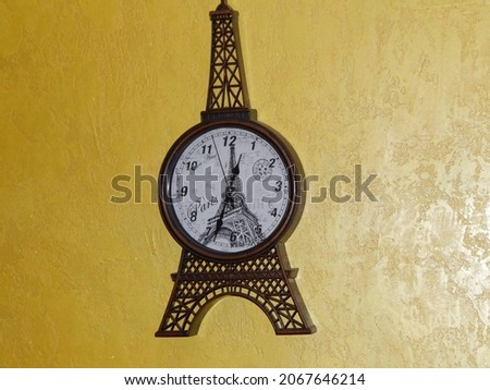 Large wall antique clock from france the city of paris, the elf tower on a yellow-golden background, with a picture of an elf tower with the inscription paris