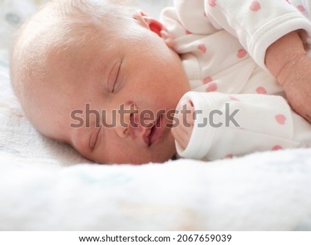 Sleeping white caucasian newborn baby closeup. Angel's kiss, stork bite birthmark Royalty-Free Stock Photo #2067659039