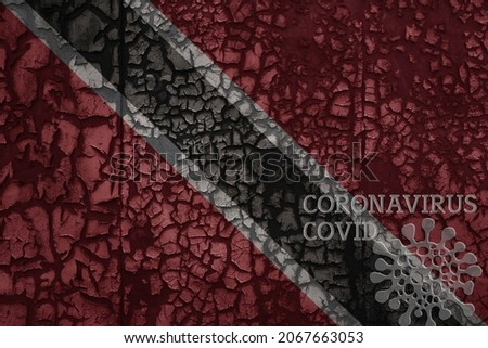 flag of trinidad and tobago on a old vintage metal rusty cracked wall with text coronavirus, covid, and virus picture.