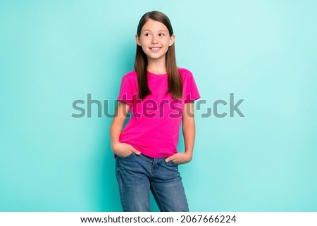 Portrait of attractive cheerful girl holding hands in pockets pondering isolated over bright teal turquoise color background