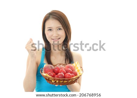 Smiling woman holding fruits