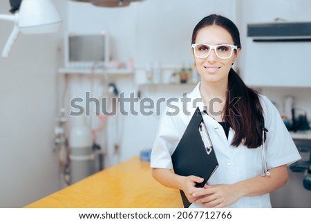 
Smiling Doctor Holding a Folder Map in Surgery Room. Medical worker standing in operation room in a hospital
