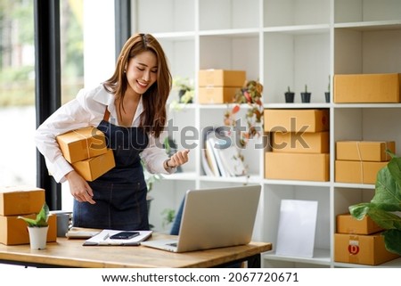 Portrait of Starting small businesses SME owners female entrepreneurs working on receipt box and check online orders to prepare to pack the boxes, sell to customers, SME business ideas online. Royalty-Free Stock Photo #2067720671