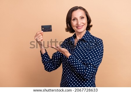 Photo of cute aged hr brunette lady index card wear dotted blouse isolated on beige color background
