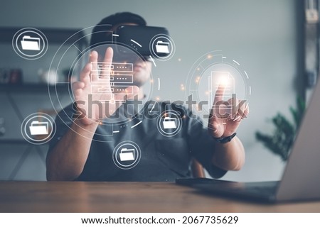 man wearing VR glasses virtual Global Internet connection metaverse, Document Management System, online documentation database and process automation to efficiently manage files, future technology. Royalty-Free Stock Photo #2067735629