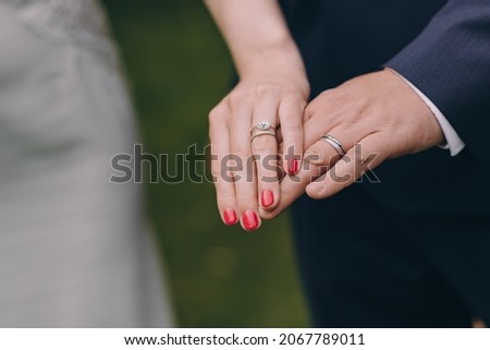 Picture of bride and groom with wedding ring. Young married couple holding hands, ceremony wedding day. Newly wed couple's hands with wedding rings. Royalty-Free Stock Photo #2067789011