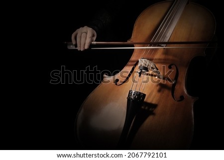 Cello player. Cellist hands playing cello with bow strings musical instrument closeup. Violoncello Royalty-Free Stock Photo #2067792101