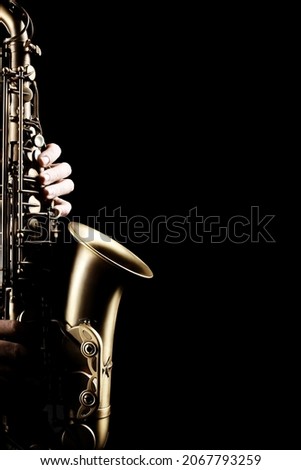 Saxophone player. Saxophonist sax jazz orchestra instrument hands isolated on black background close up Royalty-Free Stock Photo #2067793259
