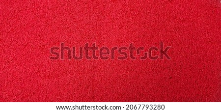 Red grass texture background taken with top view. Artificial grass textured for create a red background, food and beverages photo background