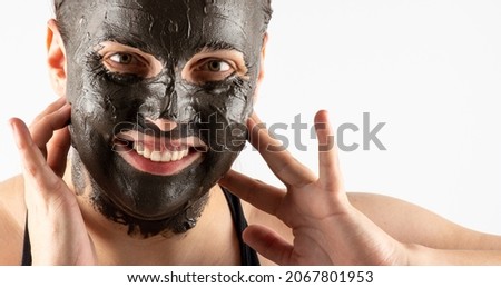Skin care. Closeup of female face applying clay mask on white background. Girl taking care of her dry compexion. Spa and beauty treatment. Beauty treatment. copy space Royalty-Free Stock Photo #2067801953