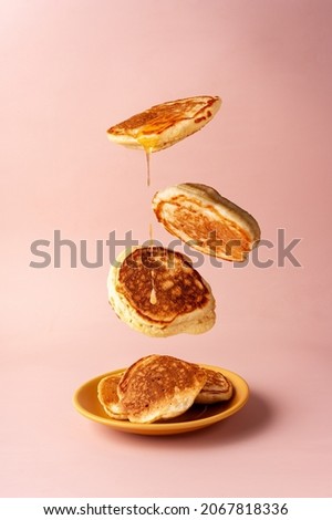 mini pancakes with jam flying food selective focus Royalty-Free Stock Photo #2067818336