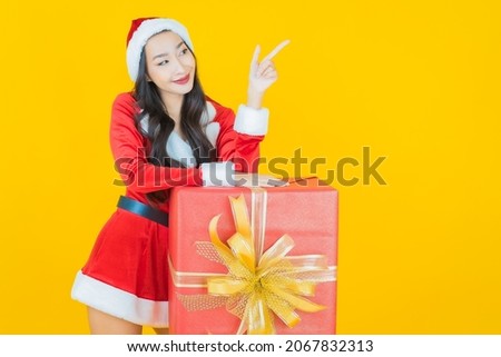 Portrait young asian woman wear christmas costume with action on yellow color background