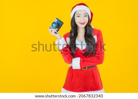 Portrait young asian woman wear christmas costume with action on yellow color background