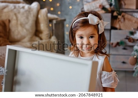 New Year's portrait of a girl on the background of a Christmas tree, Christmas mood, winter holiday, children's laughter.