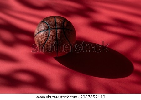 Basketball on red court floor with natural lighting. Workout online concept. Horizontal sport poster, greeting cards, headers, website and app