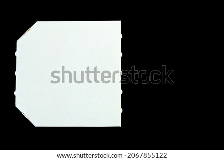 A white empty cardboard, paper pizza box on black background. Copy space, top view, flat lay. Creative holiday flyer. Sale. 