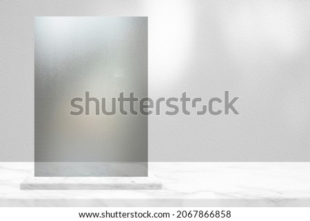 Acrylic Sign on White Marble Table with Concrete Wall Background, Suitable for Cosmetic Product Presentation Backdrop, Display, and Mock up in Christmas Concept.