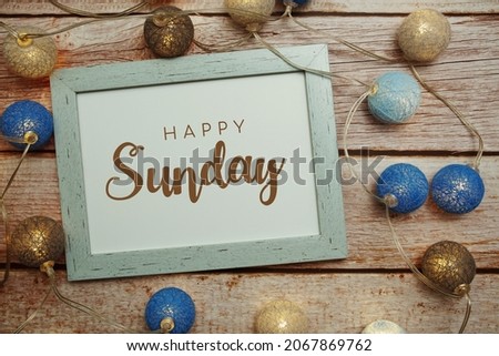 Happy Sunday card typography text with LED cotton ball on wooden background Royalty-Free Stock Photo #2067869762